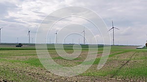 Modern wind turbines on a green landscape with a cloudscape in the background in Meinz Germany