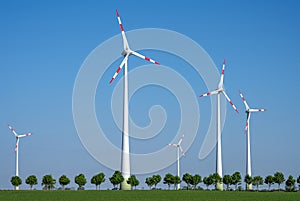 Modern wind turbines with trees