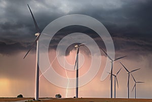 Modern windfarm located on farmland in midwest America during a lightening storm