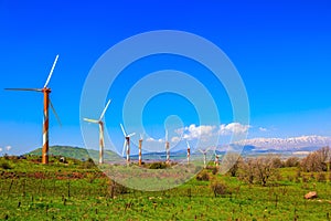 Modern windmills and snowy Hermon