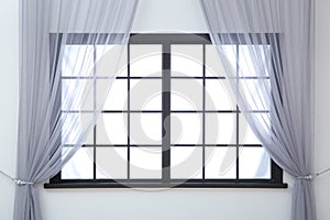 Modern window with curtains in room.