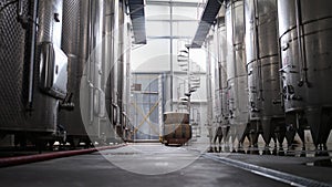 Modern winery interior with large metal tanks