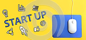 Wired optical mouse, different icons and word STARTUP on yellow background, top view. Banner design