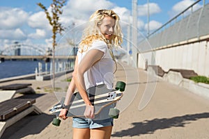 Modern woman holding longboard