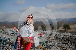 Modern woman on landfill, consumerism versus pollution concept.