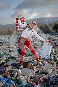 Modern woman on landfill, consumerism versus pollution concept.