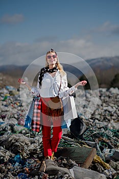 Modern woman on landfill, consumerism versus pollution concept.