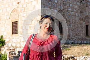 Modern Woman in Pink Blouse Posing in Front of the Mosque