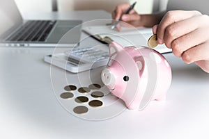 Modern woman putting Coin In pink Piggy Bank, step up growing business to success and saving for retirement concept