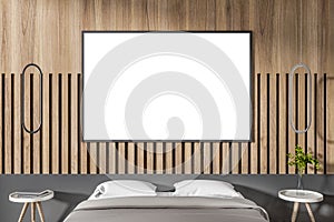 Modern wooden bedroom interior with close up of bed, empty white mock up poster on decorative wall and other items. Design and
