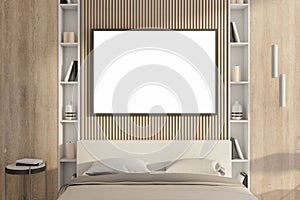 Modern wooden bedroom interior with empty white mock up poster, furniture, shelfves. Design and style concept.