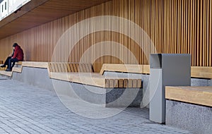 Modern wooden benches on a sunny day, public places in the city park. City improvement, urban planning, public spaces, recreation