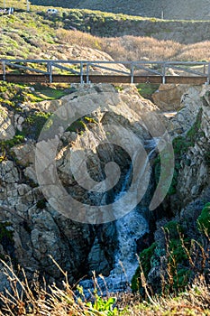 Modern Wooden Bridge Over Waterfall photo