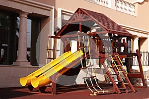 Modern wooden children playground in park with multy activities