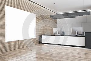 Modern wooden and concrete office reception interior with empty white mock up banner on wall, desk and computer monitors. Hotel