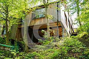 Modern wooden eco house villa facade luxury big house. Timber cottage in the Woods