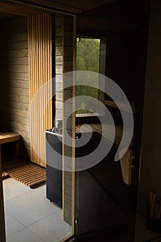 Modern wooden Finnish sauna interior with wooden benches. Wooden interior baths, wooden benches and loungers accessories