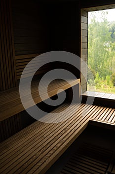 Modern wooden Finnish sauna interior with wooden benches. Wooden interior baths, wooden benches and loungers accessories