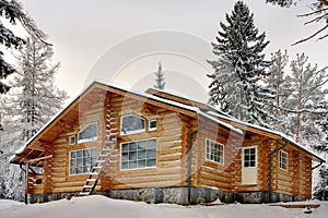 Modern wooden handmade log Vacation Home during winter.