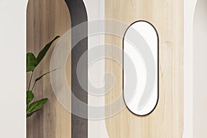 Modern wooden interior with plant and empty white oval picture frame with mock up place. Design concept.