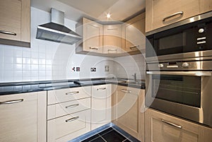 Modern wooden kitchen with silver appliances