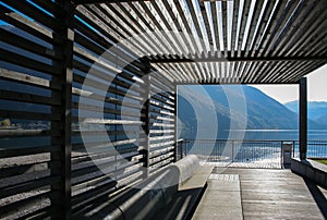 Modern wooden pavillion on the bank of Lugano lake