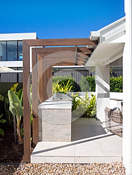 Modern wooden pergola and BBQ grill in outdoor garden