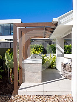 Modern wooden pergola and BBQ grill in outdoor garden photo