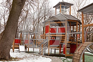 Modern wooden playground for young children during winter season
