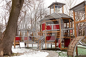 Modern wooden playground for young children during winter season