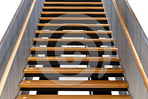 Modern wooden staircase with iron banister isolated on white background, with clipping path