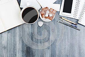 Modern wooden tabletop with smartphone and coffee