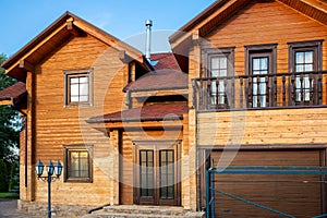 Modern wooden timber eco house villa facade during process of renovation, sanding wall for varnishing against sun burn