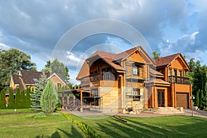 Modern wooden timber eco house villa facade during process of renovation, sanding wall for varnishing against sun burn