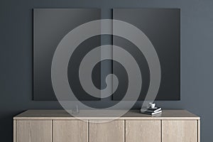 Modern wooden TV shelf with items and two empty black mock up banners on dark wall background. Interior design and living room