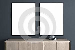 Modern wooden TV shelf with items and two empty white mock up banners on dark wall background. Interior design and living room