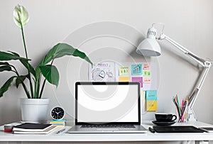 Modern work table with blank computer laptop and accessories in home office studio.Freelance designer or blogger concepts ideas