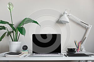 Modern work table with blank computer laptop and accessories in home office studio.Freelance designer or blogger concepts ideas photo