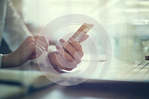 Modern workplace woman using mobile phone in