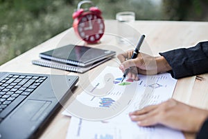 Modern workplace woman using mobile phone sitting at wooden table in office