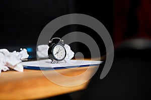 Modern workplace, wooden office desk in hardlight, sunligt with clock, sheet of paper