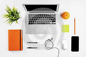 Modern workspace with coffee cup, smartphone, paper, notebook, tablet and laptop copy space on white color background. Flat lay