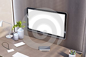 Modern workspace featuring a computer with a blank screen, desk lamp, notebooks, and plants, against a wooden wall backdrop. 3D