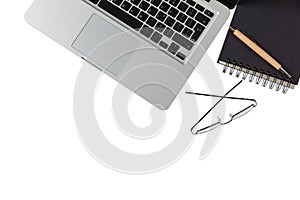 Modern workspace, laptop and black notepad on white background, copy space, top view