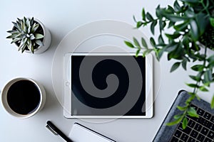Modern Workspace: Tablet, Coffee, Plant, and Keyboard