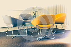 Modern yellow and grey armchairs in reception area in corpo