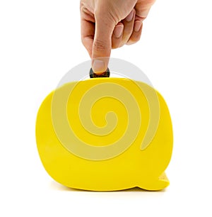 Modern yellow piggy bank, human hand is dropping coin to save money the represent to banking, financial freedom. white and