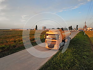 Modern yellow truck on country road