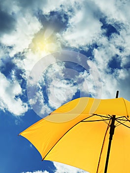 Modern yellow umbrella against sky, space for text. Sun protection