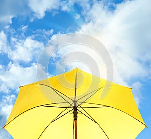Modern yellow umbrella against sky. Sun protection